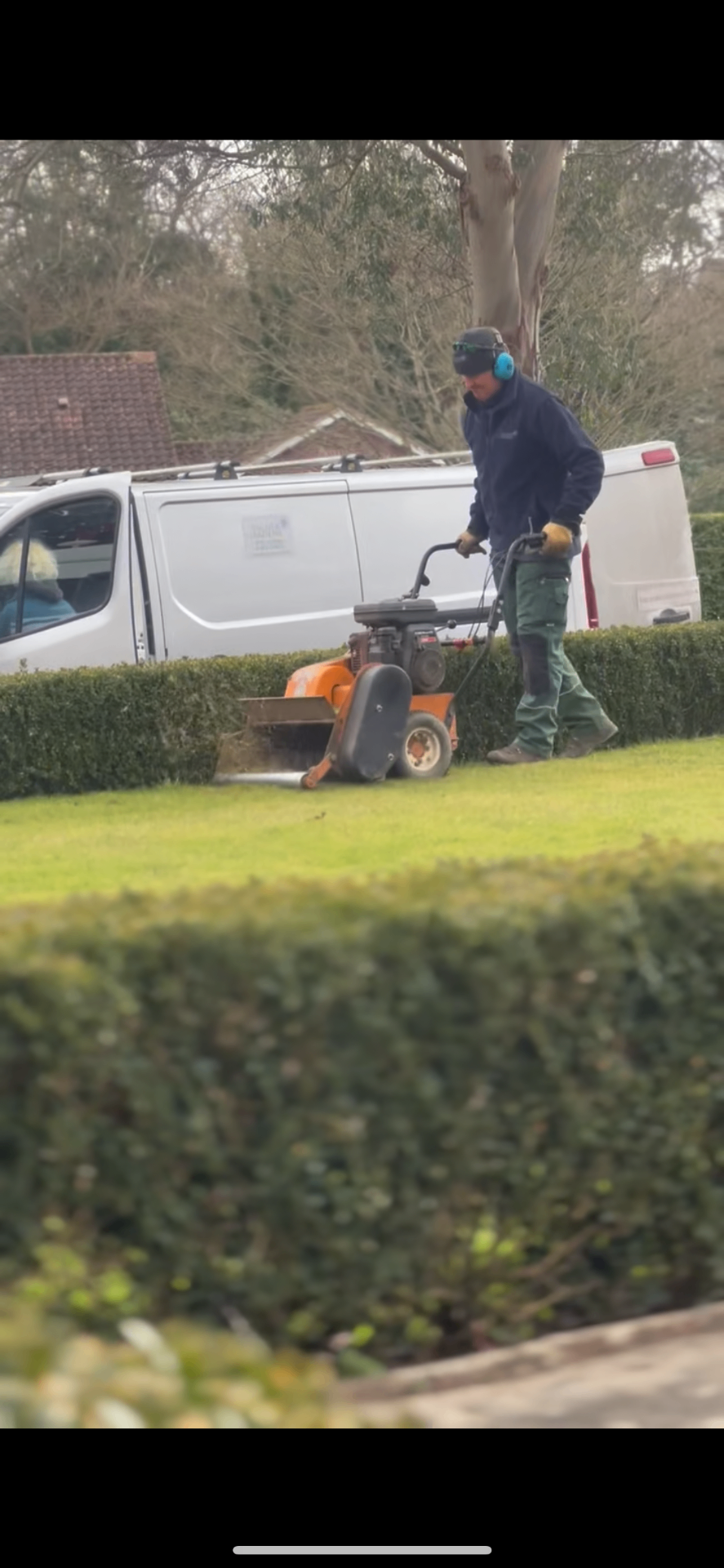 Vacher Gardens team on-site scarifying a lawn in East Sussex